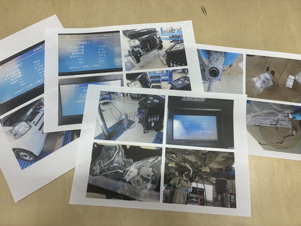 伊賀市のモリタ自動車:作業工程の写真をお客様に見せて誠実に説明する様子